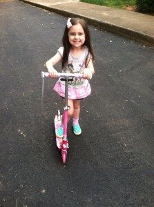 Our 4 1/2 year old grand daughter Eden on her new scooter