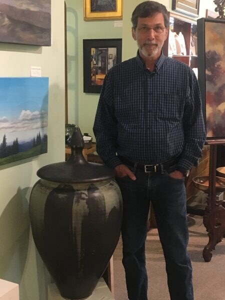 Ralph Mello in the gallery with one of his jars