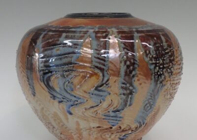 #361  7 1/2″ x 9″  $295 textured jar with stained glass